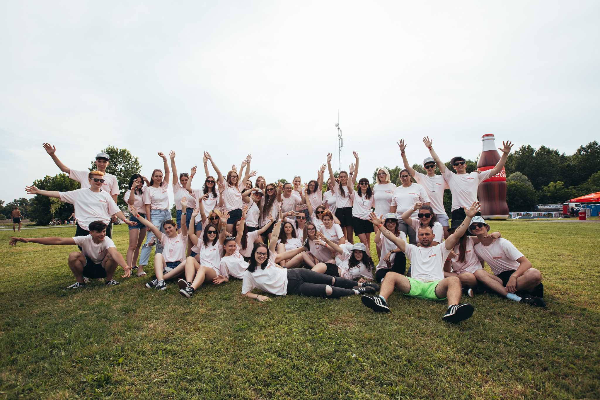 A group of volunteers celebrating and posing for a picture.